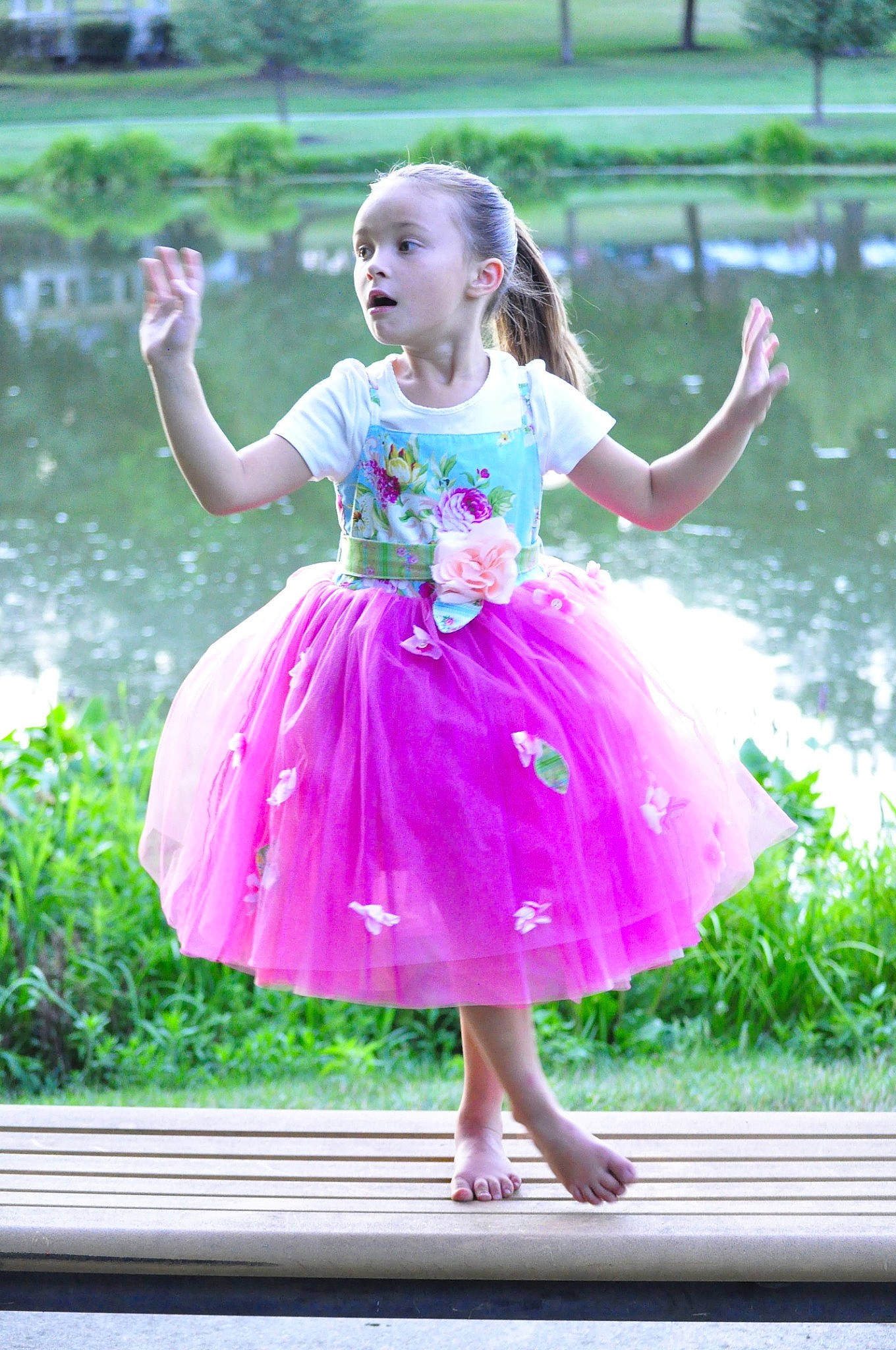 Mckenzie is registered to the contest to win money with this photo: baby_toddler_clothing, child, day_dress, dress, event, fun, grass, happy, leisure, magenta, one_piece_garment, people_in_nature, person, pink, plant, purple, recreation, standing, surprise, toddler