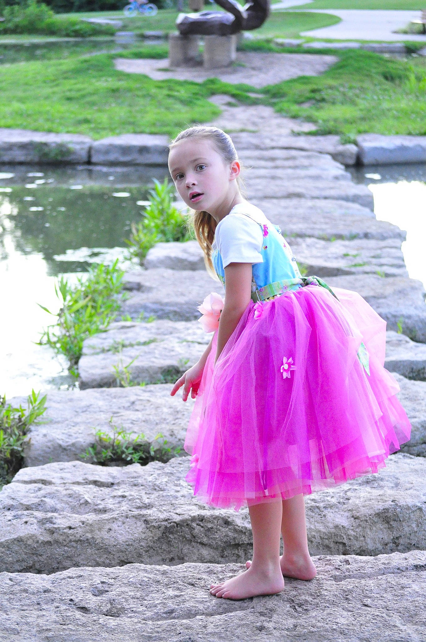 Mckenzie is registered to the contest to win money with this photo: baby_toddler_clothing, botany, child, day_dress, dress, fun, grass, hairstyle, happy, leisure, magenta, pattern, person, pink, plant, public_space, purple, sandal, spring, toddler