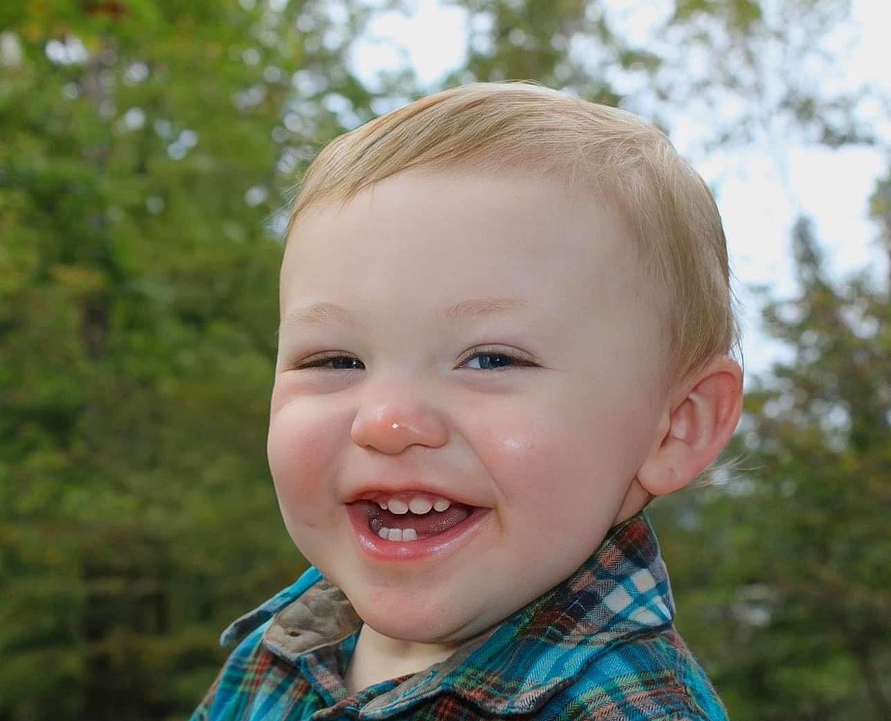 Emmet joined the competition — help win amazing prizes! baby, baby_laughing, baby_toddler_clothing, blond, cheek, child, face, grass, happy, iris, joy, lip, nose, pattern, people_in_nature, person, plaid, plant, sleeve, smile