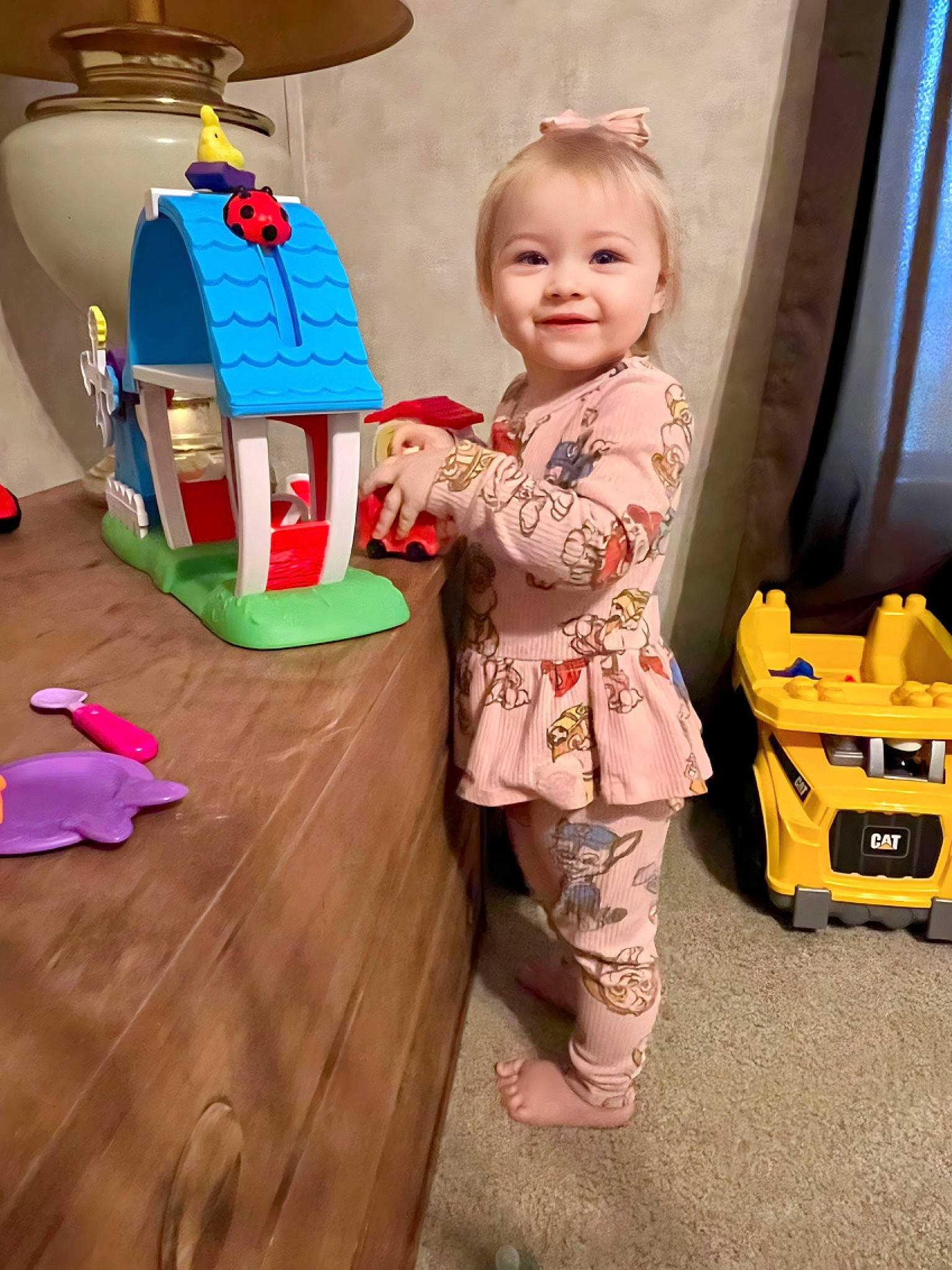Skye is registered to the contest to win money with this photo: baby, baby_products, baby_toddler_clothing, baby_toys, cardboard, child, flooring, fun, joy, person, pink, plastic, play, product, room, smile, toddler, toy, toy_vehicle, vacation