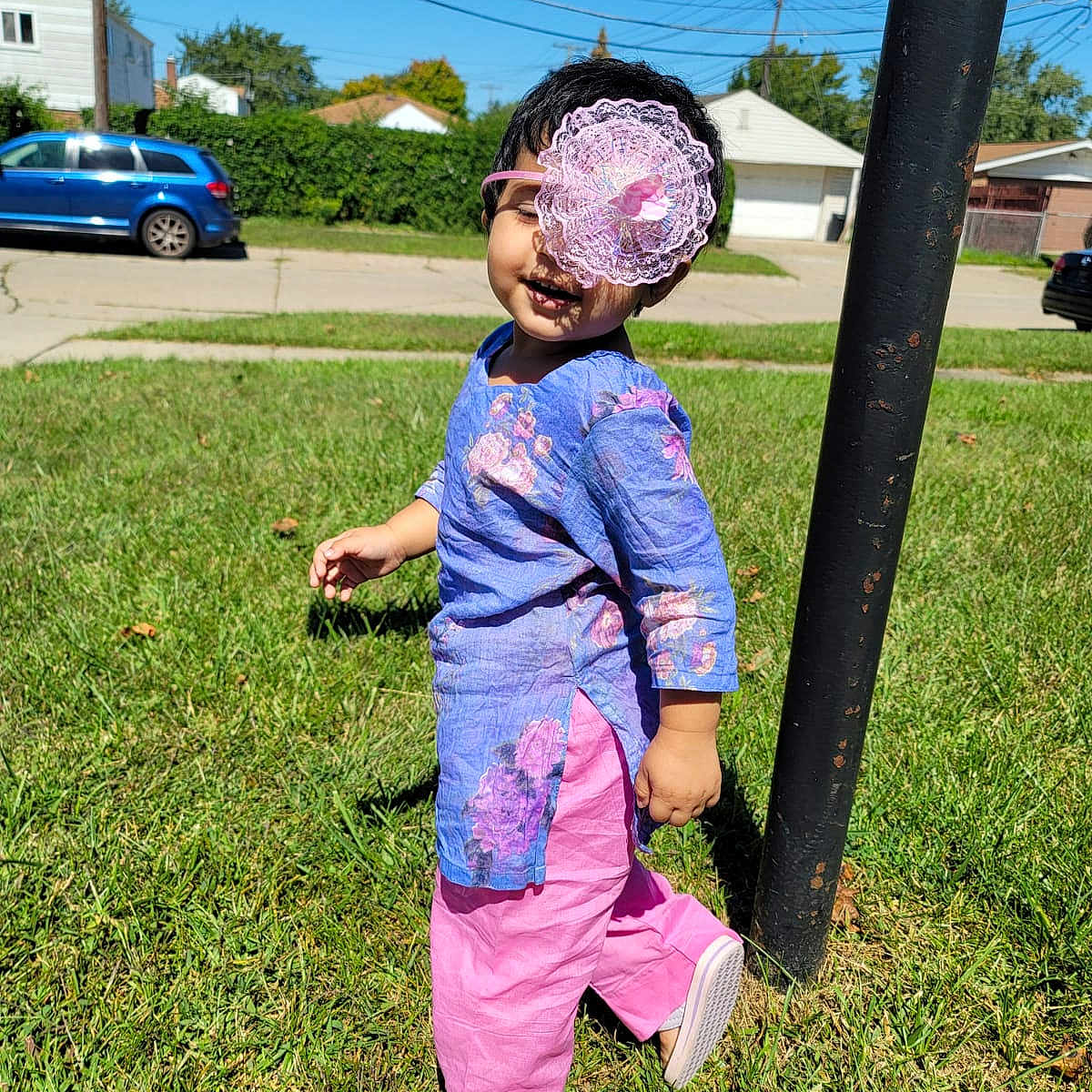 Anam joined the competition — help win amazing prizes! blue, cloud, electric_blue, fun, grass, grassland, happy, lawn, leisure, magenta, motor_vehicle, people_in_nature, plant, recreation, sky, tire, toddler, tree, wheel, woody_plant