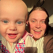 Charlie is registered to the contest to win money with this photo: baby, child, woman, smiling, happy, portrait, indoor, sunlight, face, person, clothing, cheerful, family, wall, photograph, head, eyes, skin, hair, room