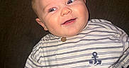 Grayson is registered to the contest to win money with this photo: baby, child, infant, smiling, happy, portrait, face, eyes, outdoorless, seated, shirt, striped_shirt, anchor, clothing, chair, furniture, indoors, candid, flash_photography, close_up