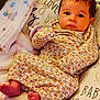 Luna is registered to the contest to win money with this photo: baby, infant, floral_onesie, blanket, pillow, pacifier, feet, face, eyes, cute, comfortable, laying_down, soft, home, child, newborn, warm, resting, close_up, portrait
