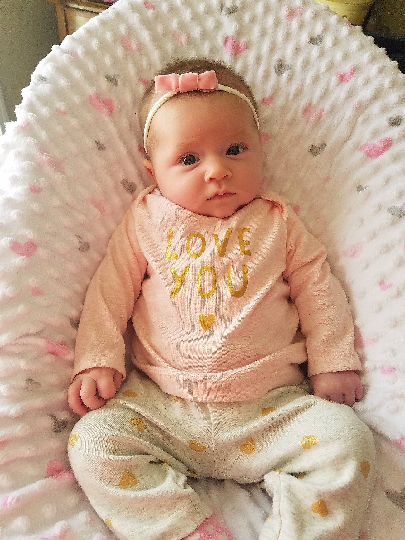 Brooke is registered to the contest to win money with this photo: baby, cheek, child, eye, face, head, person, pink, sitting, skin, smile, toddler