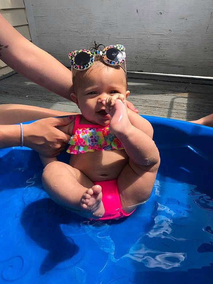 Abriella is registered to the contest to win money with this photo: baby, child, cool, eyewear, fun, games, glasses, goggles, inflatable, leisure, muscle, person, personal_protective_equipment, pool, recreation, summer, sunglasses, swimming_pool, toddler, vacation