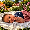Aurora is registered to the contest to win money with this photo: awake, baby, blanket, child, colorful, crochet, face, fist, flowers, garden, grass, infant, lying_down, nature, outdoor, patriotic_clothing, portrait, smiling, stars, stripes