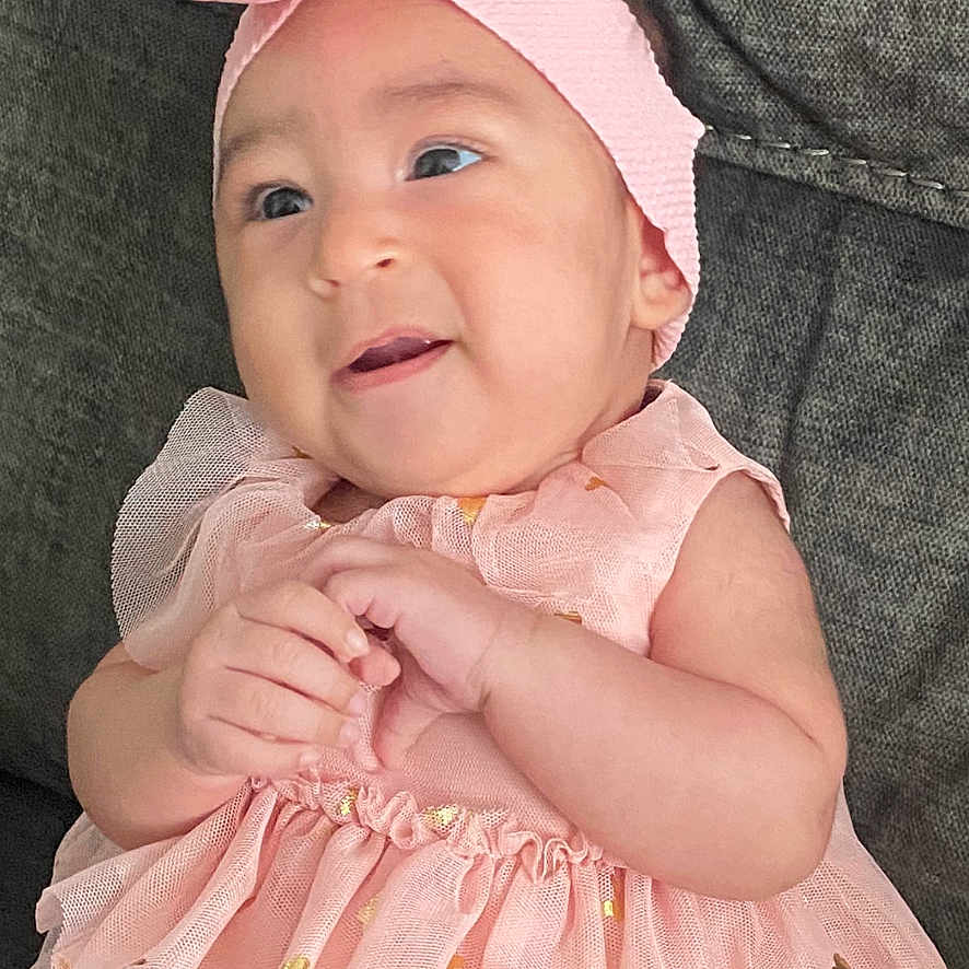 Hailey is registered to the contest to win money with this photo: baby, infant, girl, pink_dress, headband, flower, cute, smiling, portrait, child, sitting, happy, indoors, clothing, fashion, cute_outfit, baby_fashion, toddler, young_child, adorable