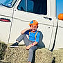 Erick is registered to the contest to win money with this photo: child, boy, kid, orange_glasses, hat, bow_tie, blue_shirt, gray_pants, black_shoes, hay_bales, vintage_truck, white_truck, pumpkin, smile, sitting, autumn, outdoor, clear_sky, portrait, costume