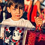 Erick joined the competition — help win amazing prizes! child, boy, mickey_mouse, tshirt, shopping_bag, portrait, sunlight, shadow, outdoor, crowd, gift_bag, closeup, haircut, expression, holding, red_color, blurry_background, casual_clothing, summer, candid