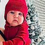 Elliam joined the competition — help win amazing prizes! baby, infant, child, red_hat, beanie, pom_pom, red_outfit, christmas_tree, ornaments, frosted_tree, window_blinds, holiday, portrait, close_up, cute, cheeks, gaze, parent_arm, indoor, soft_lighting
