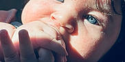 Elliam is registered to the contest to win money with this photo: baby, infant, close_up, blue_eyes, hand, fingers, mouth, face, portrait, sunlight, shadow, cheek, hair, car_seat, skin, eyelashes, teething, adorable, palm, candid