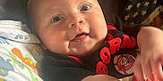 Maddox joined the competition — help win amazing prizes! arm, baby, blanket, casual, child, clothing, comfort, cute, dinosaur, eyes, face, indoor, infant, lying, pattern, person, playful, skin, smile, young