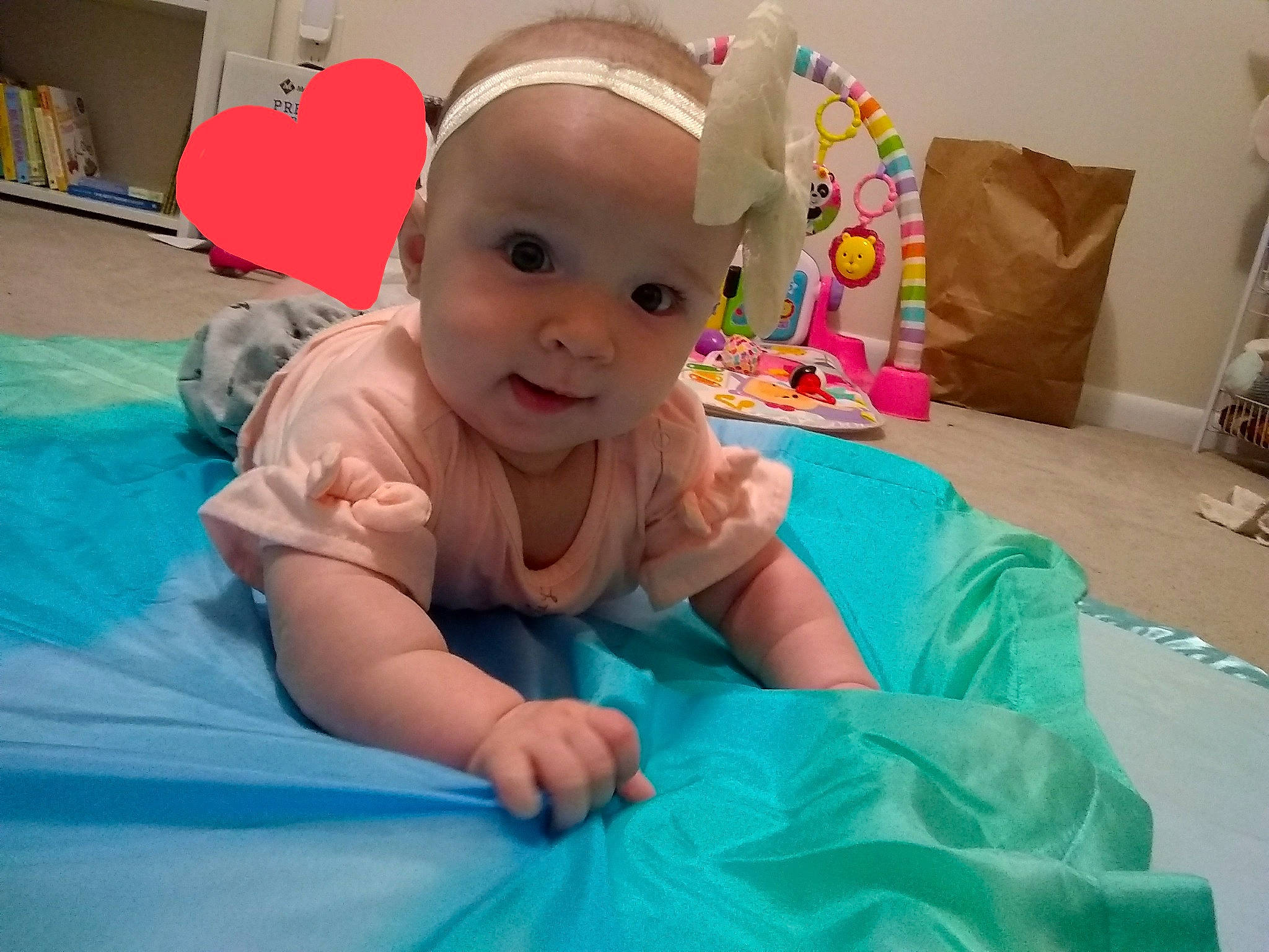 Gwen is registered to the contest to win money with this photo: baby, baby_playing_with_toys, baby_toddler_clothing, child, comfort, event, fun, hairstyle, happy, head, human_body, leisure, magenta, person, pink, recreation, room, skin, smile, t_shirt