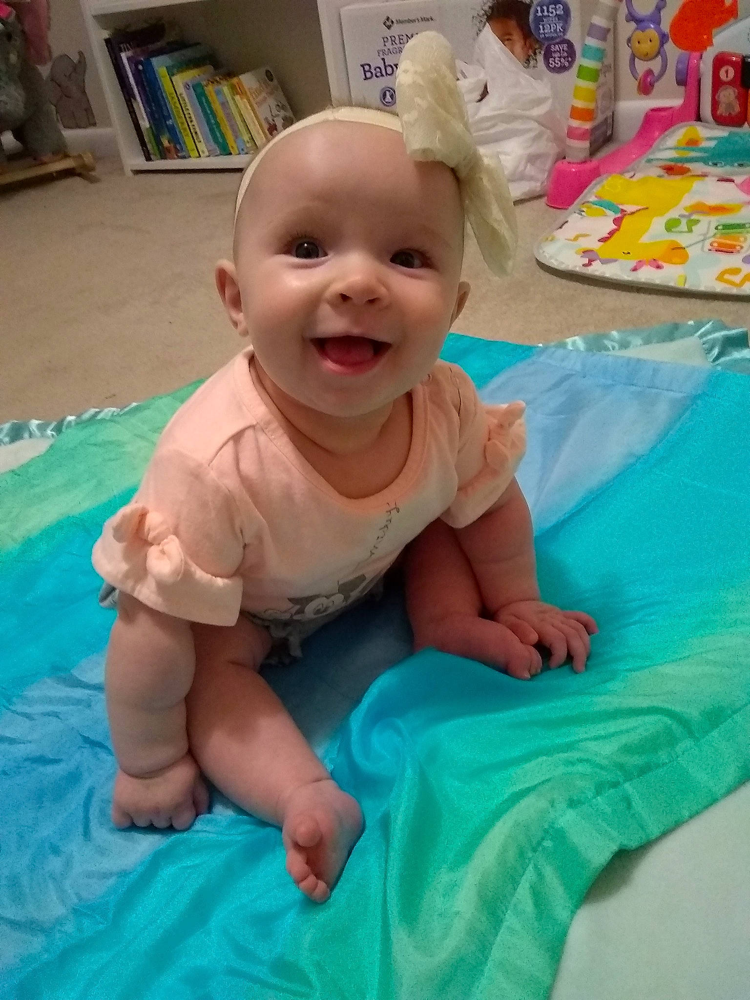 Gwen is registered to the contest to win money with this photo: baby, baby_laughing, baby_products, baby_toddler_clothing, cheek, child, event, fun, happy, leisure, person, pink, play, product, recreation, room, shelf, skin, smile, toddler