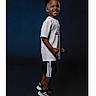 Zaiden joined the competition — help win amazing prizes! child, boy, smiling, standing, white_tshirt, black_shorts, sneakers, sporty, studio, portrait, dark_background, happy, casual_clothing, young, person, fashion, footwear, pose, full_body, confident