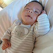 Nicholas is registered to the contest to win money with this photo: baby, infant, pajamas, striped_clothing, koala_patch, bed, bedding, white, sleepy, relaxed, hand, face, child, indoors, soft_light, portrait, cute, resting, young, sleepwear
