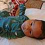 Nicholas joined the competition — help win amazing prizes! baby, infant, bed, blanket, onesie, clothing, face, person, child, sleepwear, indoor, portrait, cute, young, lying_down, cozy, soft_light, bedroom, comfort, relaxation