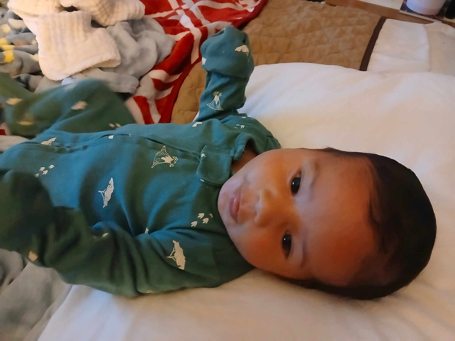 Nicholas joined the competition — help win amazing prizes! baby, infant, bed, blanket, onesie, clothing, face, person, child, sleepwear, indoor, portrait, cute, young, lying_down, cozy, soft_light, bedroom, comfort, relaxation