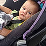 baby, car_seat, child, blanket, blue_eyes, seatbelt, outdoor, stroller, serious_expression, infant, clothing, person, toddler, fabric, purple, green_shirt, push_button, warning_label, closeup, face