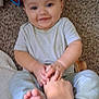 baby, child, smiling, hand, foot, carpet, toy, indoor, person, holding, playful, cute, infant, sitting, closeup, skin, clothing, interaction, happy, young
