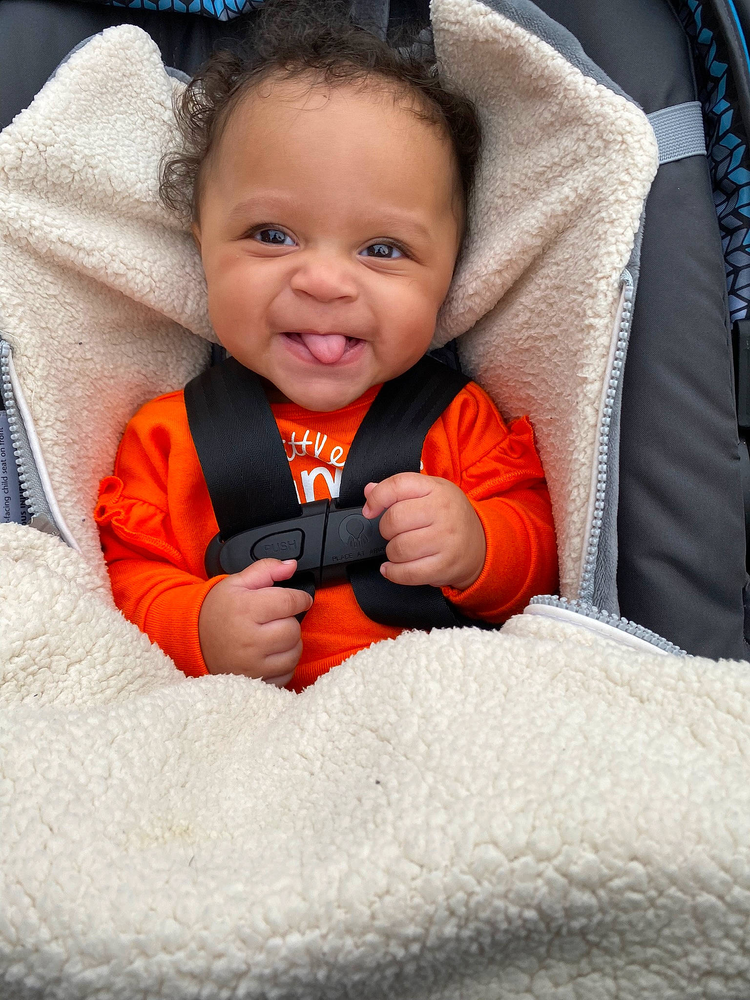 Braelyn joined the competition — help win amazing prizes! baby, baby_in_car_seat, baby_products, baby_toddler_clothing, cheek, child, comfort, eye, finger, gesture, happy, iris, nose, orange, person, photograph, skin, sleeve, smile, thumb