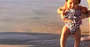 Amira joined the competition — help win amazing prizes! adult, beach, child, happy, holding, nature, outdoor, person, play, sand, shadow, smile, summer, sunlight, sunshine, swimsuit, toddler, vacation, water, waves
