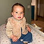 toddler, child, baby, sitting, indoor, clothing, vest, jeans, socks, face, hands, cushion, pattern, fur, blouse, expression, portrait, cute, rosy_cheeks, blurred_background
