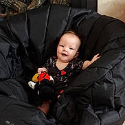 Kamila is registered to the contest to win money with this photo: animal, baby, bird, blanket, bodypart, car, car_interior, carseat, clothing, coat, couch, face, furniture, head, jacket, person, photography, portrait, transportation, vehicle