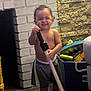Jacob joined the competition — help win amazing prizes! toddler, child, toy, indoor, barefoot, smiling, brick_wall, stone_wall, toy_box, shorts, person, floor, play, happy, young_child, home, furniture, living_room, standing, grinning