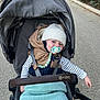 Valentin a rejoint le concours — aidez-le/la à gagner de superbes lots ! baby, stroller, pacifier, blanket, hat, vest, child, outdoor, pathway, greenery, walking, cute, comfort, winter_clothing, infant, seatbelt, baby_accessories, relaxed, casual, smiling