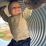 Valentin participe au concours pour gagner de l'argent avec cette photo : toddler, child, smiling, sweater, jeans, playground, metal_tunnel, outdoor, sunlight, happy, portrait, kneeling, play, candid, fun, curved_surface, daylight, clothing, person, expression