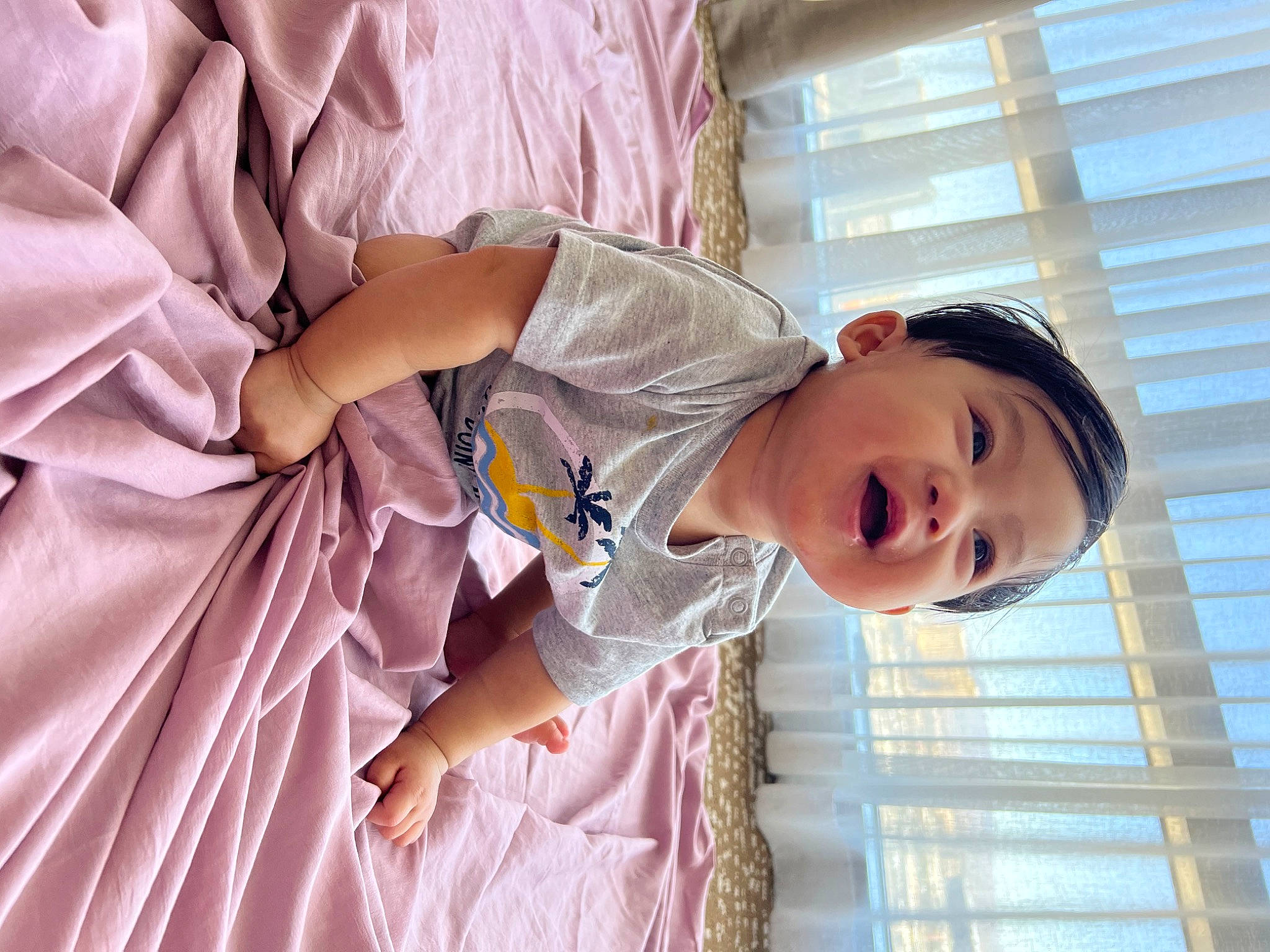 Chozen is registered to the contest to win money with this photo: baby, baby_products, child, comfort, face, facial_expression, fun, happy, linens, magenta, mouth, person, pink, room, skin, sleeve, smile, t_shirt, toddler, vacation