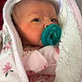 baby, bed, blanket, bodypart, bonnet, clothing, face, finger, furniture, hand, hat, head, hood, knitwear, newborn, person, photography, portrait, sweater, towel