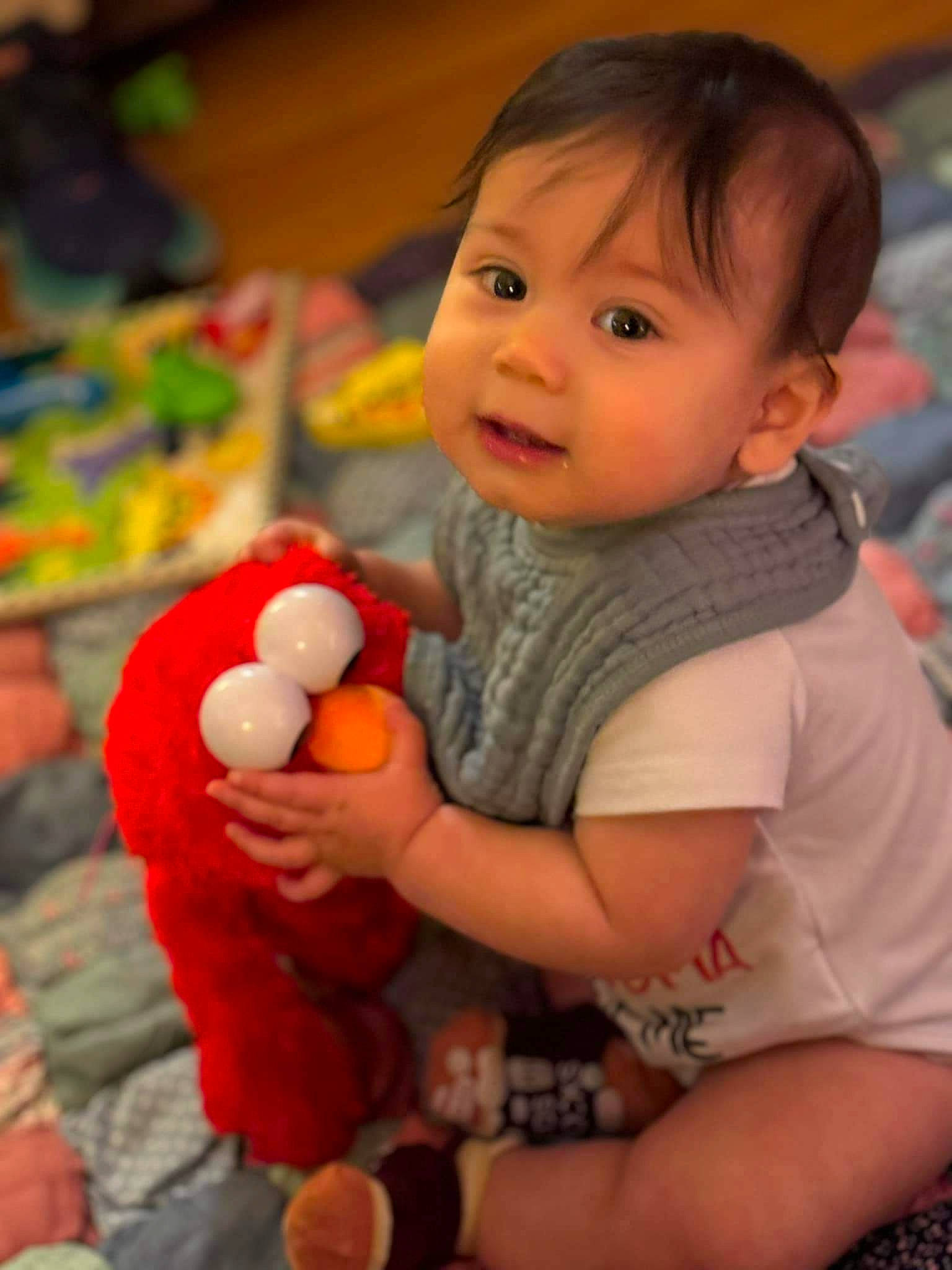 Judah is registered to the contest to win money with this photo: arm, baby, baby_playing_with_toys, cheek, child, eye, facial_expression, finger, fun, hand, happy, human_body, iris, leisure, nose, person, skin, smile, toddler, toy