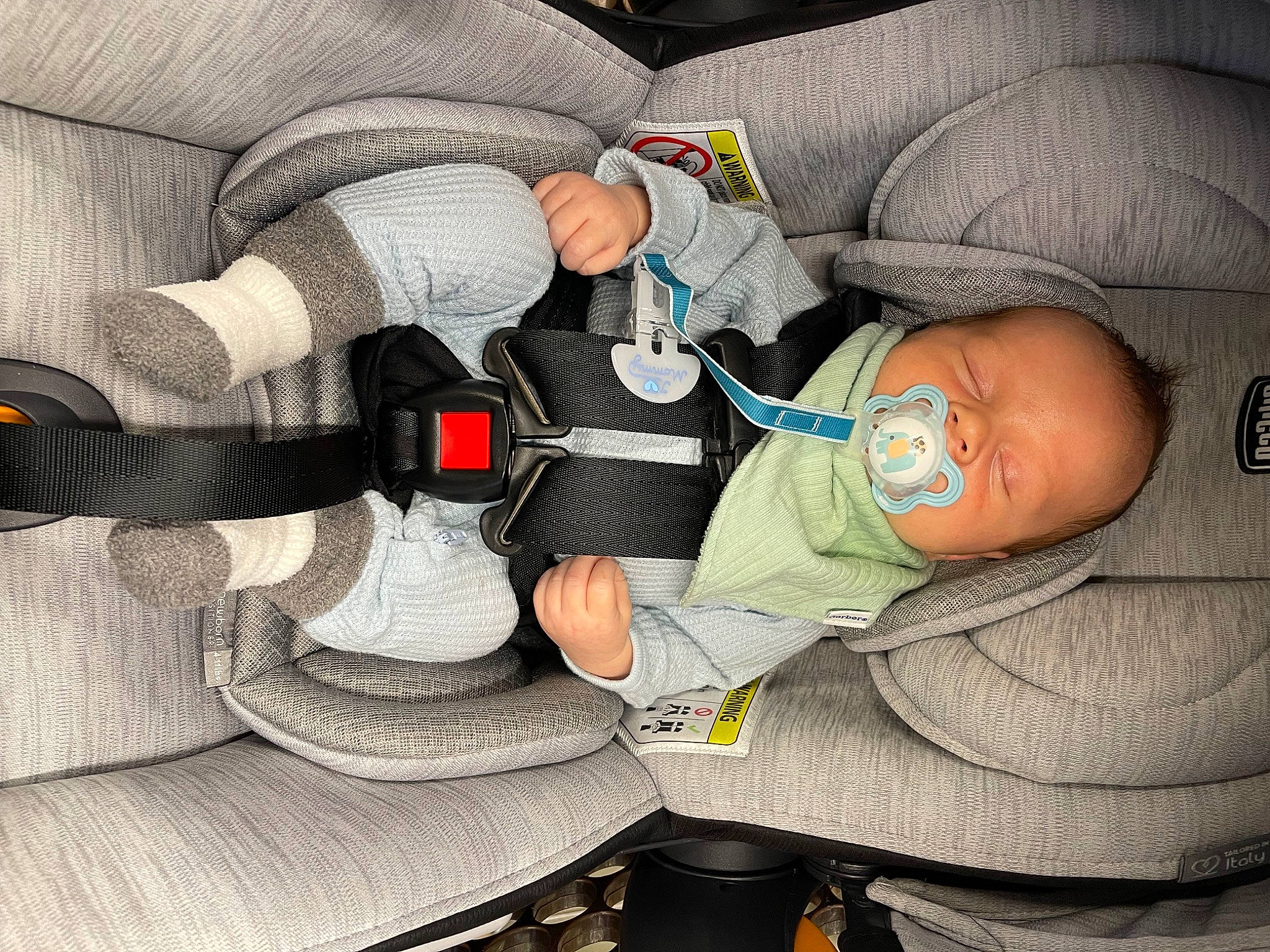 Logan is registered to the contest to win money with this photo: auto_part, baby, baby_carriage, baby_in_car_seat, baby_products, baby_sleeping, baby_toddler_clothing, car_seat, carmine, child, comfort, finger, hat, human_body, lap, nail, person, service, sitting, sleep