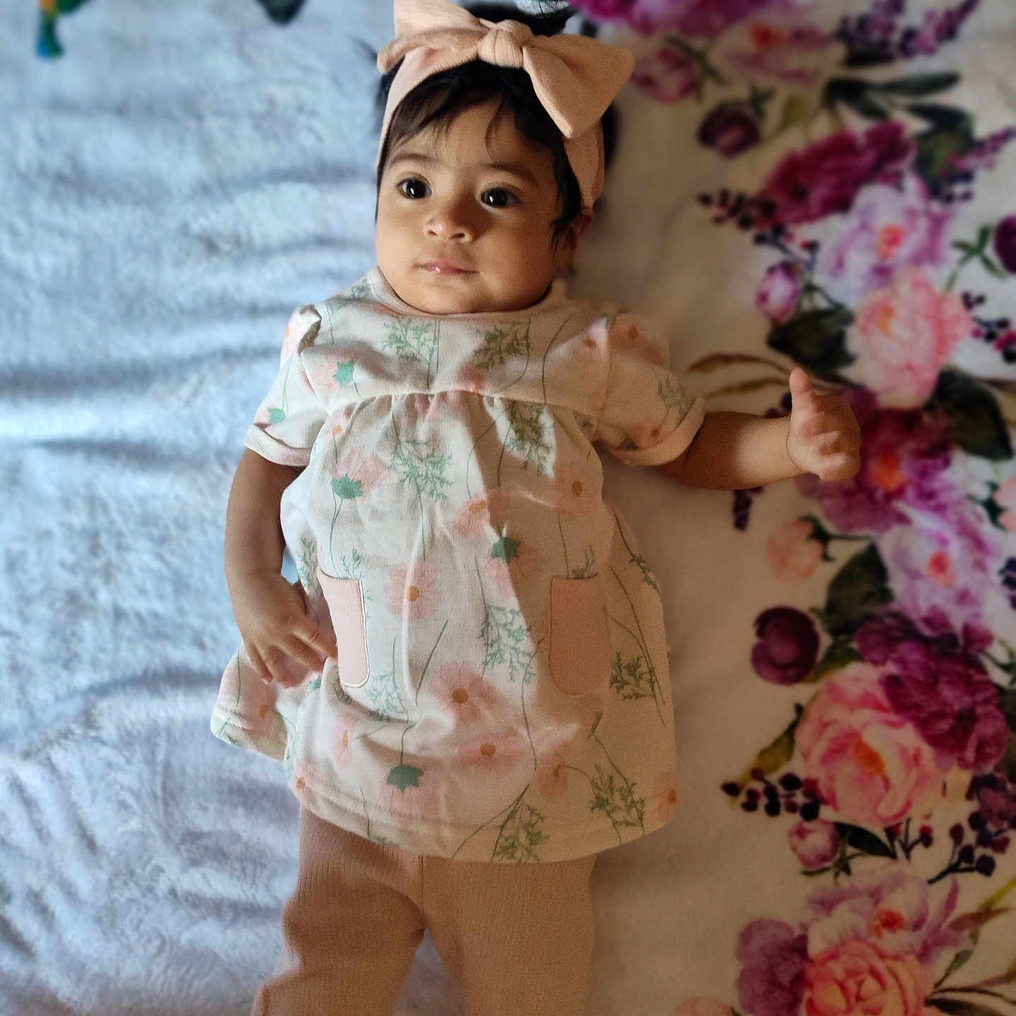 Ellie is registered to the contest to win money with this photo: accessories, baby, bonnet, cap, clothing, doll, dress, face, flower, flowerarrangement, flowerbouquet, formalwear, hat, head, person, photography, plant, portrait, rose, toy