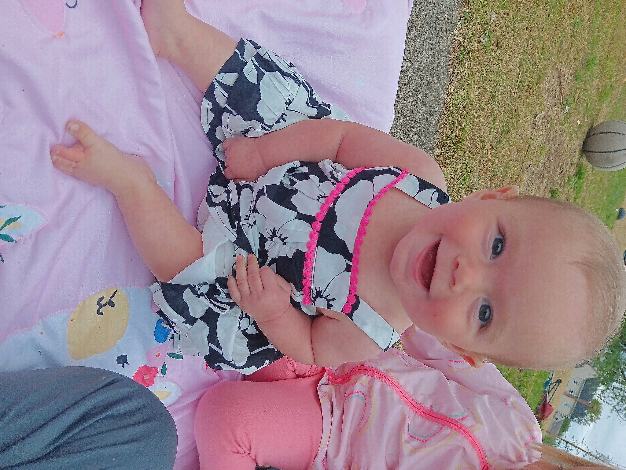 Novalynn is registered to the contest to win money with this photo: baby, baby_toddler_clothing, beauty, child, dress, finger, fun, gesture, grass, happy, joy, pattern, person, pink, plant, skin, sleeve, smile, spring, summer