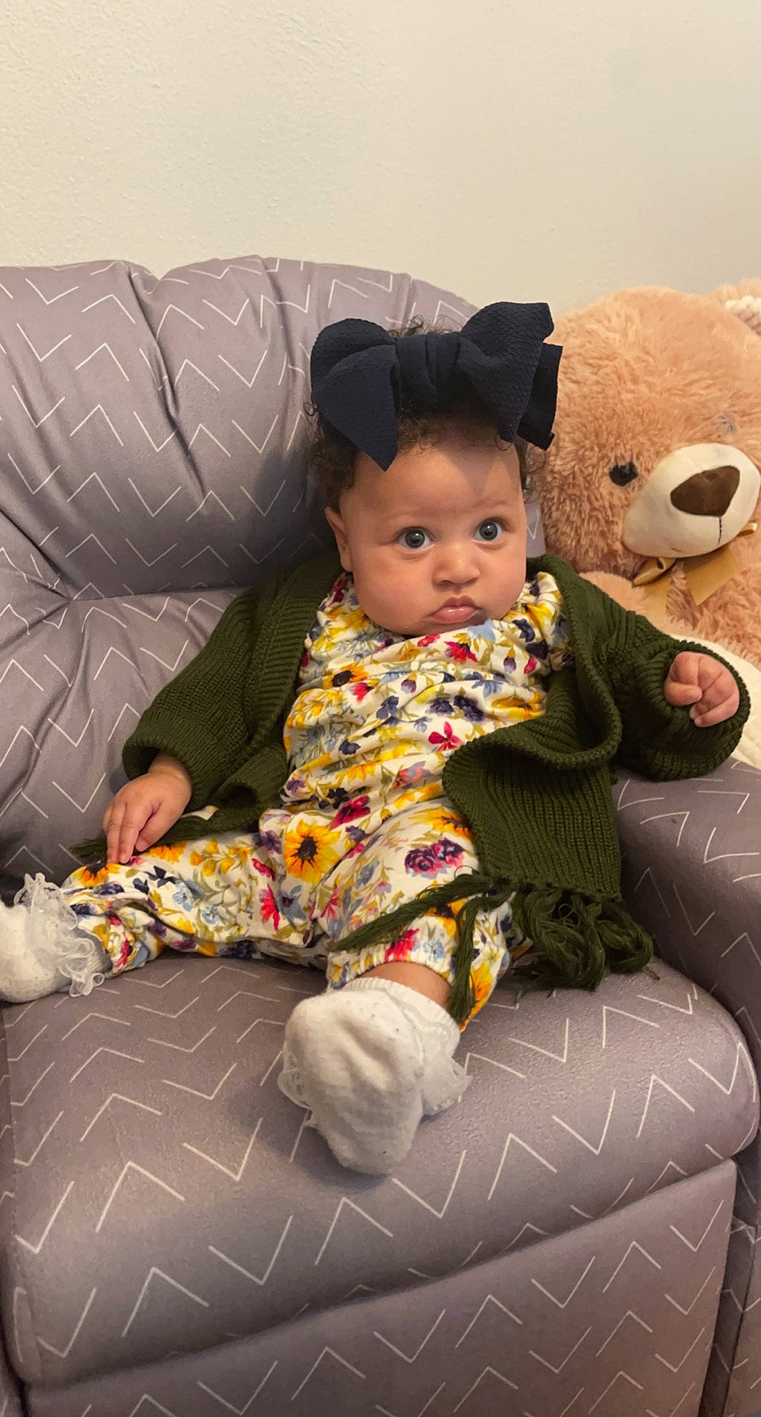 Leighton joined the competition — help win amazing prizes! baby, baby_toddler_clothing, child, comfort, couch, facial_expression, flooring, fun, happy, human_leg, pattern, person, room, sitting, skin, sleeve, stuffed_toy, teddy_bear, textile, toddler