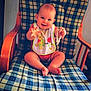 ézia participe au concours pour gagner de l'argent avec cette photo : baby, beads, bib, checkered_pattern, child, clothing, cute, face, furniture, happy, head, indoor, infant, legs, person, playful, rocking_chair, sitting, smiling, wooden_furniture