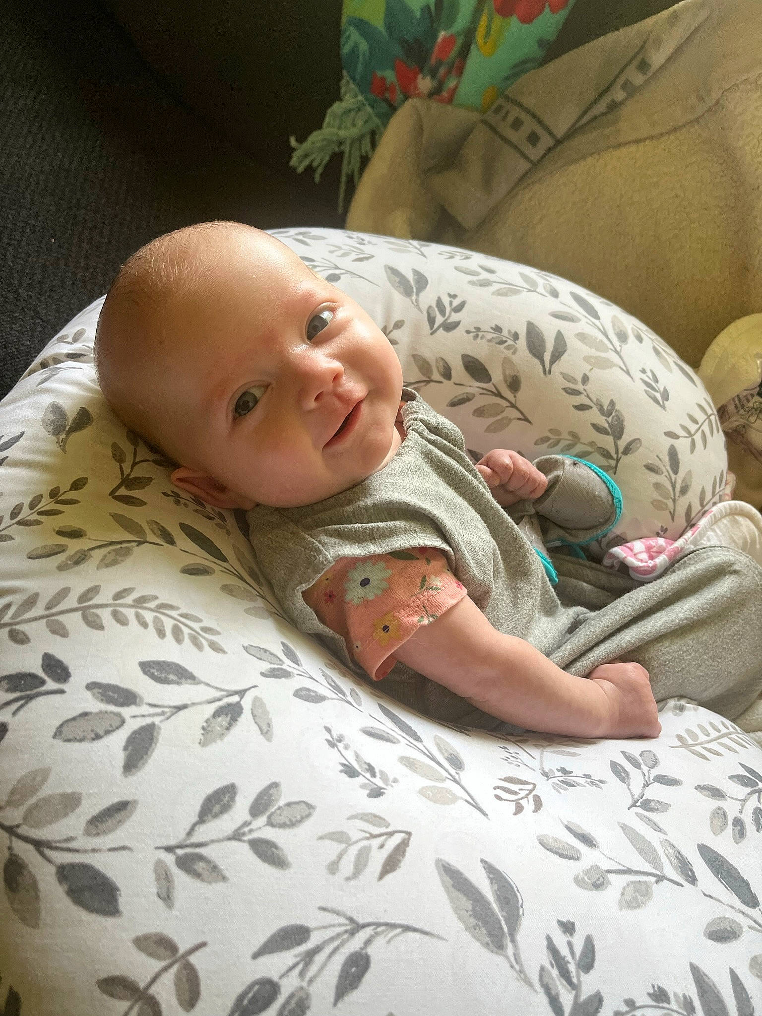 Nora joined the competition — help win amazing prizes! baby, baby_toddler_clothing, bedding, bedtime, cheek, child, comfort, facial_expression, finger, linens, mouth, nose, pattern, person, room, sitting, skin, sleeve, smile, textile