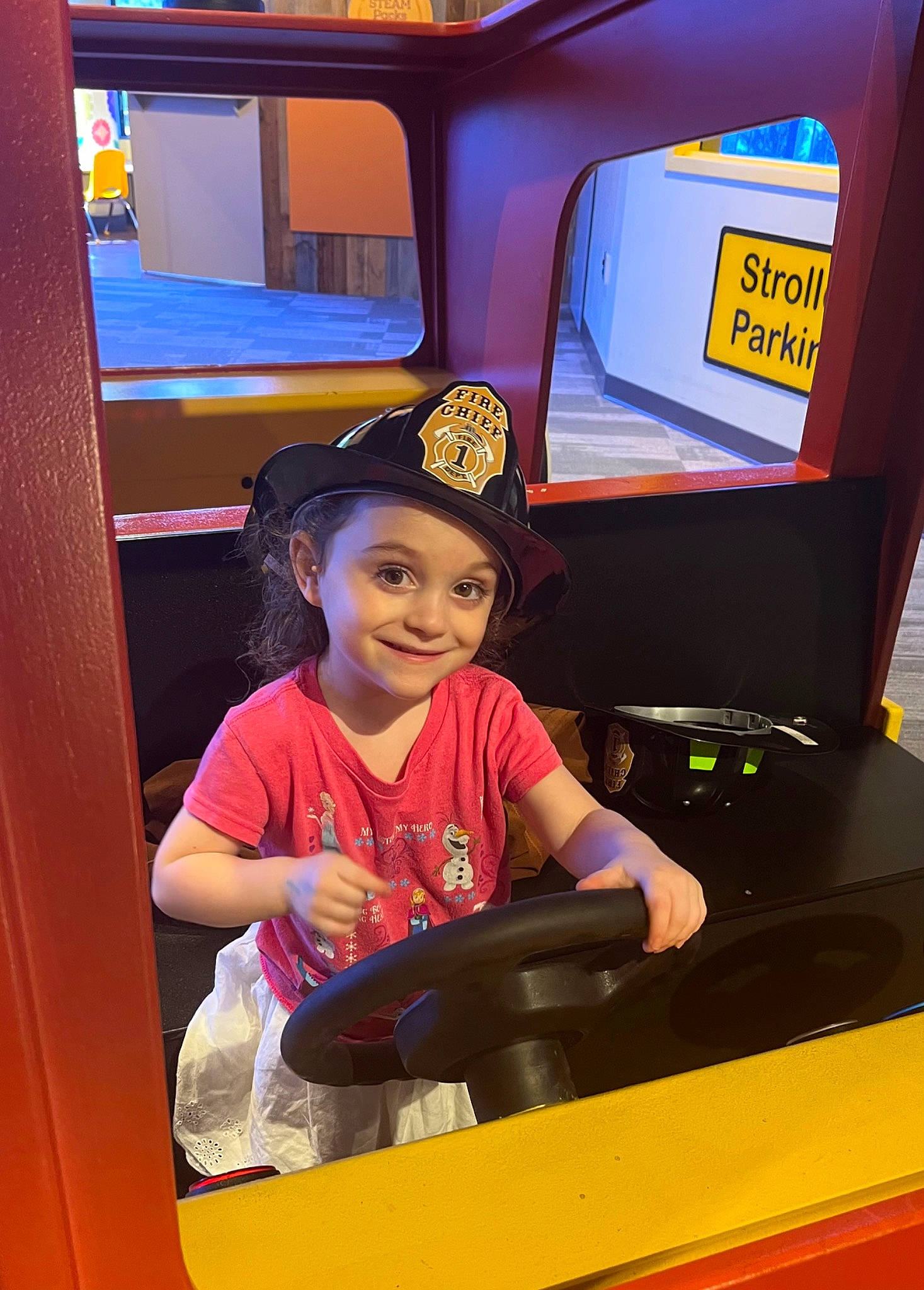 Avalyn is registered to the contest to win money with this photo: auto_part, automotive_design, automotive_exterior, baseball_cap, bumper, child, display_device, electric_blue, electronic_device, fun, happy, headwear, joy, leisure, motor_vehicle, person, recreation, smile, t_shirt, toddler