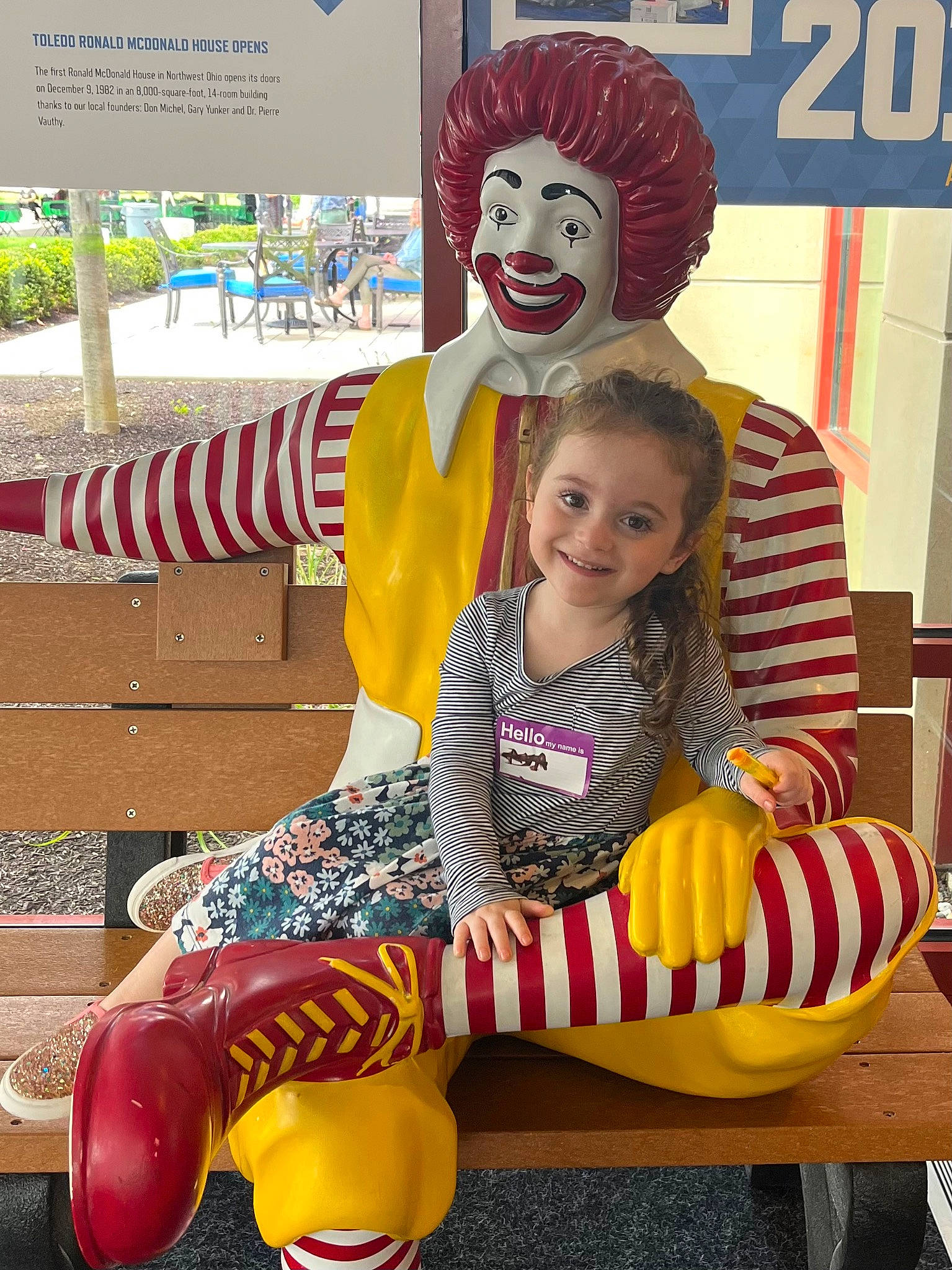Avalyn is registered to the contest to win money with this photo: chair, child, clown, costume, entertainment, event, facial_expression, fun, happy, hat, joy, leisure, logo, performing_arts, person, play, recreation, riding_toy, sitting, smile