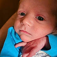 Russell joined the competition — help win amazing prizes! baby, blanket, blue_clothing, close_up, cute, expression, face, hand, head, indoors, infant, newborn, person, portrait, skin, sleepwear, small_fingers, soft_texture, warm_lighting, young_child