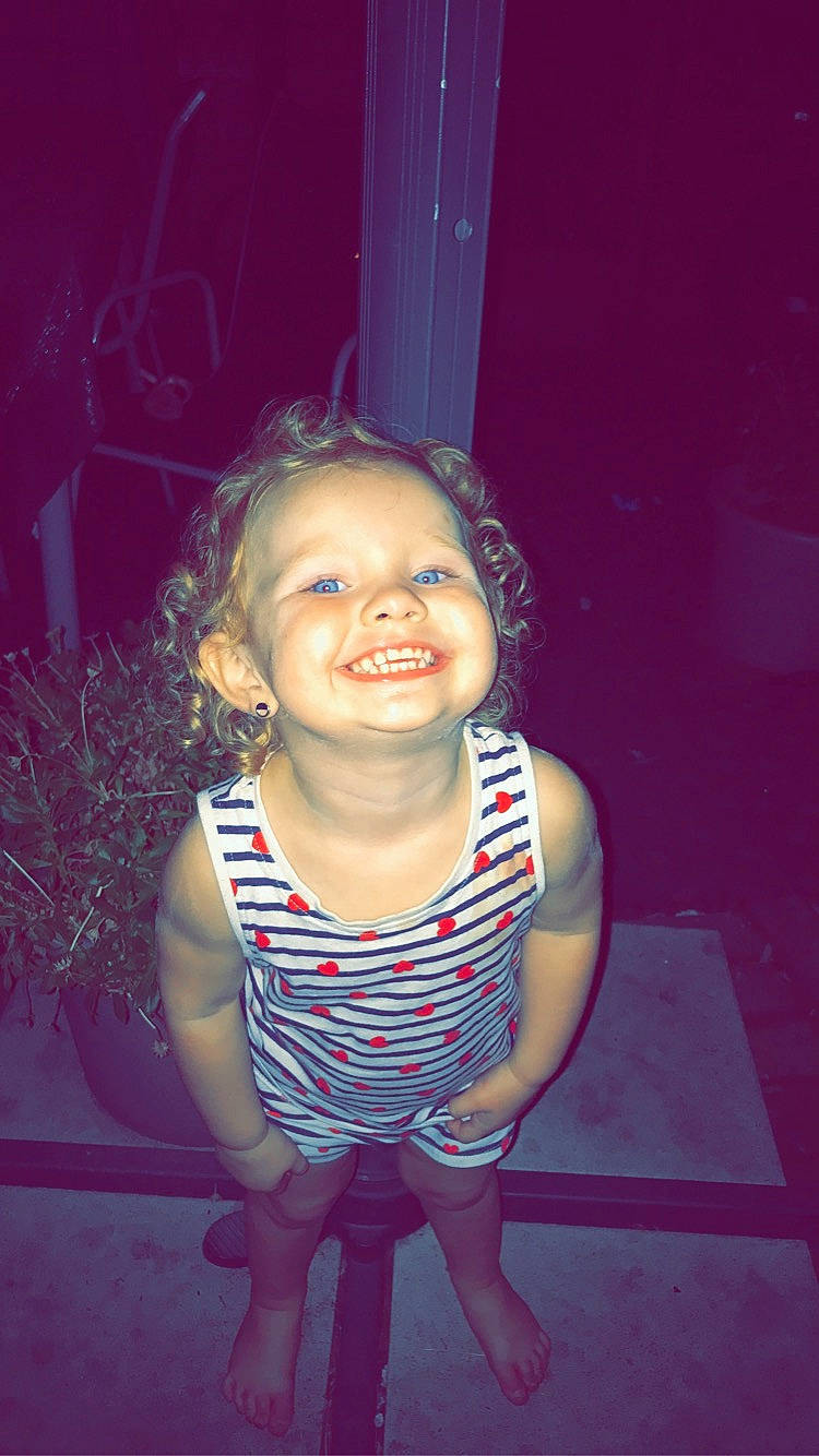 Kayna a rejoint le concours — aidez-le/la à gagner de superbes lots ! cheek, child, eye, face, facial_expression, fun, happy, head, joy, laugh, magenta, person, photography, pink, purple, sitting, skin, smile, standing, toddler