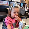 brown_hair, casual, child, contemplative, dining, drink, fast_food, food, girl, high_chair, indoor, juice_box, menu, person, pink_sweatshirt, restaurant, seat, snack, table, white_bow