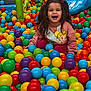 ball, child, face, female, football, girl, head, indoorplayarea, indoors, outdoorplayarea, outdoors, person, photography, playarea, portrait, soccer, soccerball, sphere, sport, toy