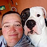 animal, black_spot, brown_eyes, closeup, companion, cute, dog, face, friendship, furniture, hoodie, indoor, person, pet, photography, portrait, selfie, smile, wall, white_dog