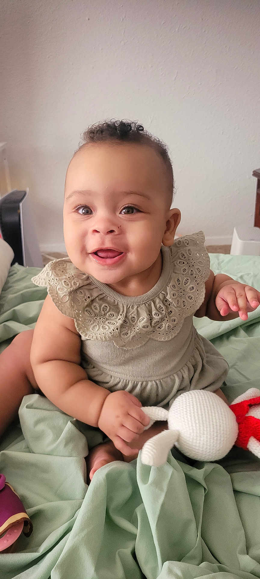 Avani joined the competition — help win amazing prizes! baby, child, smile, happy, cute, indoor, toy, knitted_toy, dress, lace, blanket, sitting, infant, person, skin, hand, face, eyes, mouth, curly_hair