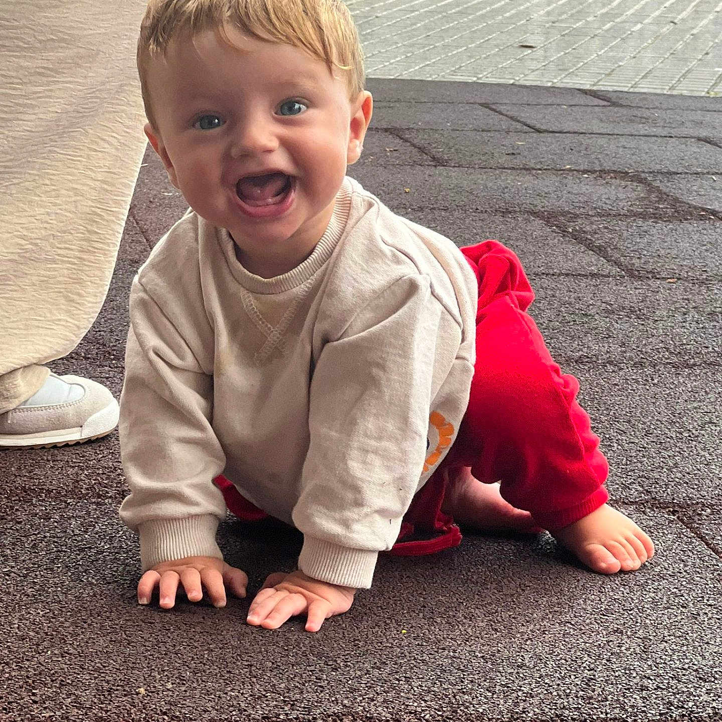 Julen joined the competition — help win amazing prizes! baby, beige_sweater, blue_eyes, casual_clothing, child, crawling, face, footwear, happy, joyful, natural_light, outdoor, pavement, person, red_pants, shoe, short_hair, smiling, texture, toddler